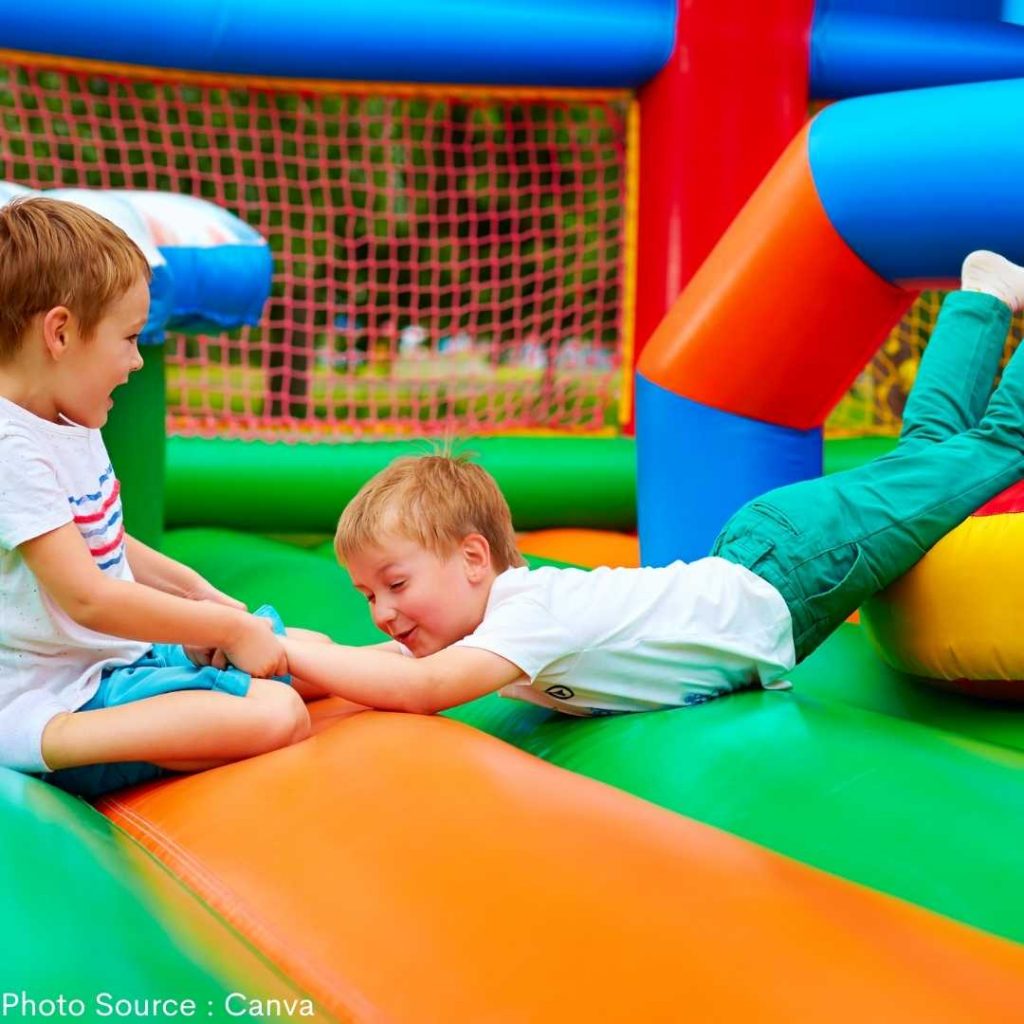kids playing in inflatable slide