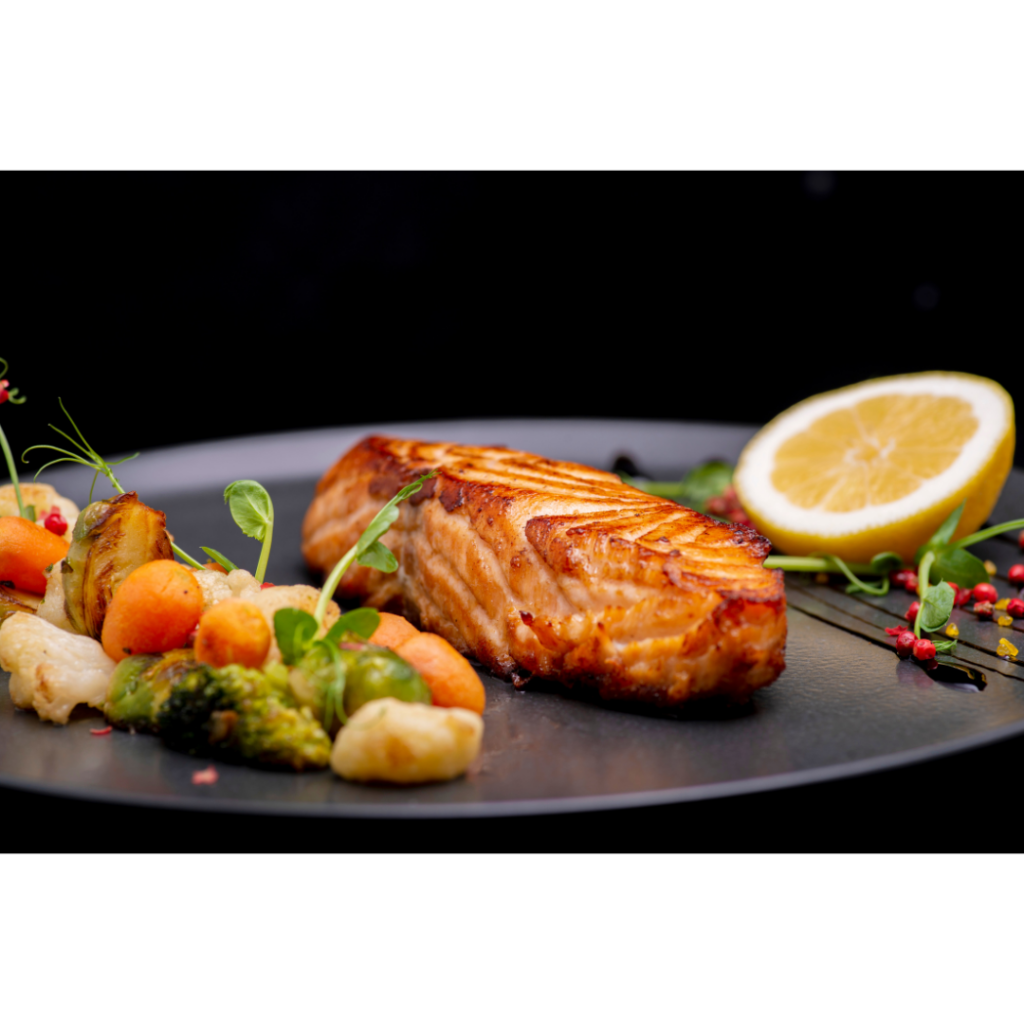 Wooden Grilled Salmon with lemon on the side
