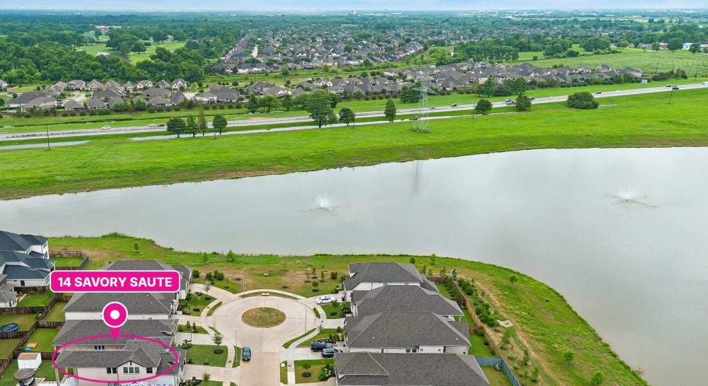 Aerial view of 14 Savory Saute Dr marked with a pink pin on a quiet cul-de-sac street near the lake in Harvest Green, Richmond TX